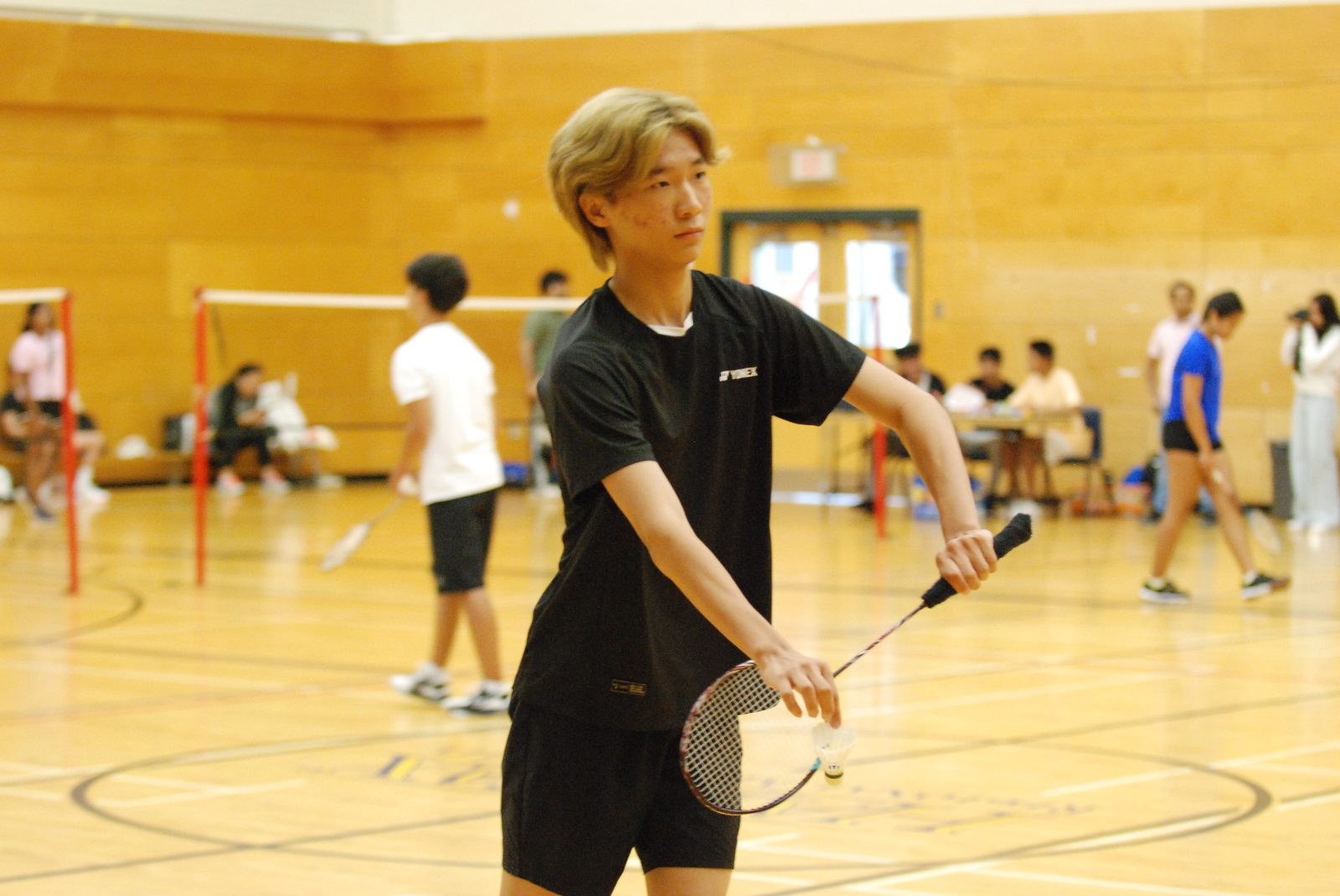 Player serving with the crowd behind